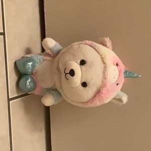 I’m selling a white bear in a unicorn onesie the colors on the onesie is pastel